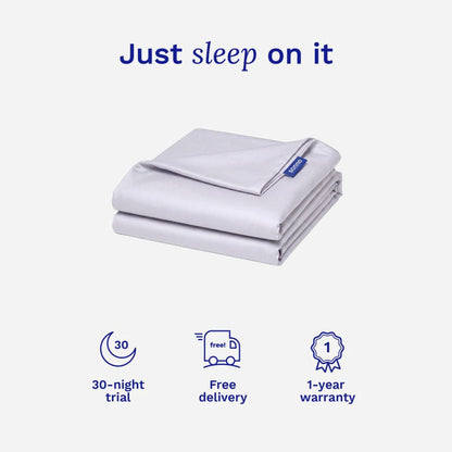 Folded Tencel bed sheets with 'Just sleep on it' text and product benefits on a white background