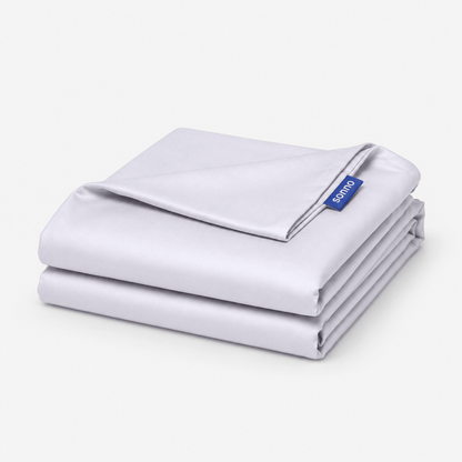 A folded light grey foldable mattress sheet or bedding set with a small blue brand tag reading 'SONNO' on a clean white background.
