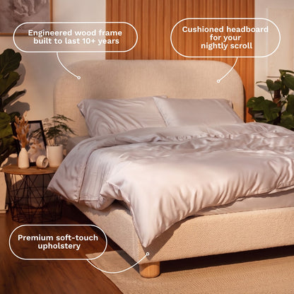 Beige upholstered bed with cushioned headboard and engineered wood frame in a bedroom setting.