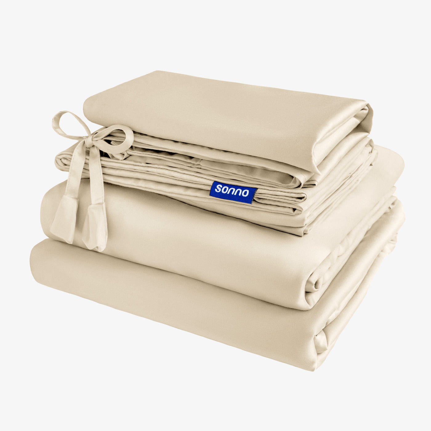 Sonno cream; light coloured bedding set arranged with soft sheets and pillowcases, accentuated by a decorative ribbon tie. The elegant collection is set against a light background, showcasing its luxurious feel and enhancing bedroom aesthetics. The Sonno logo is prominently displayed