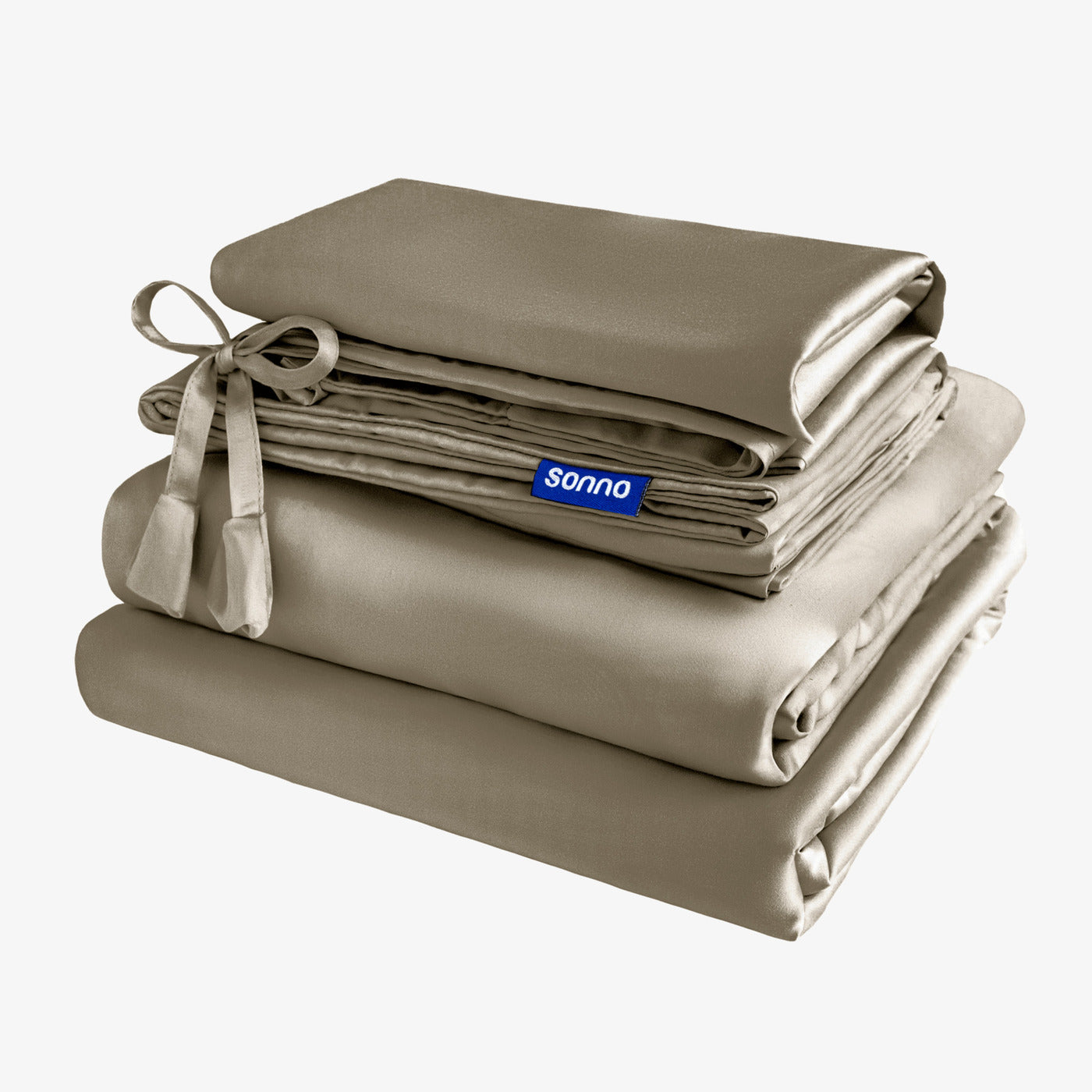 Sonno mocha bedding set neatly arranged with soft sheets and pillowcases, featuring a decorative ribbon tie. The collection is displayed against a light background, highlighting its luxurious texture and quality. This image emphasizes essential bedding solutions for a stylish bedroom, with the Sonno logo clearly visible.