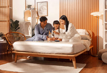 Family playing board games on Sonno Signature Bed Frame in a Japandi bedroom