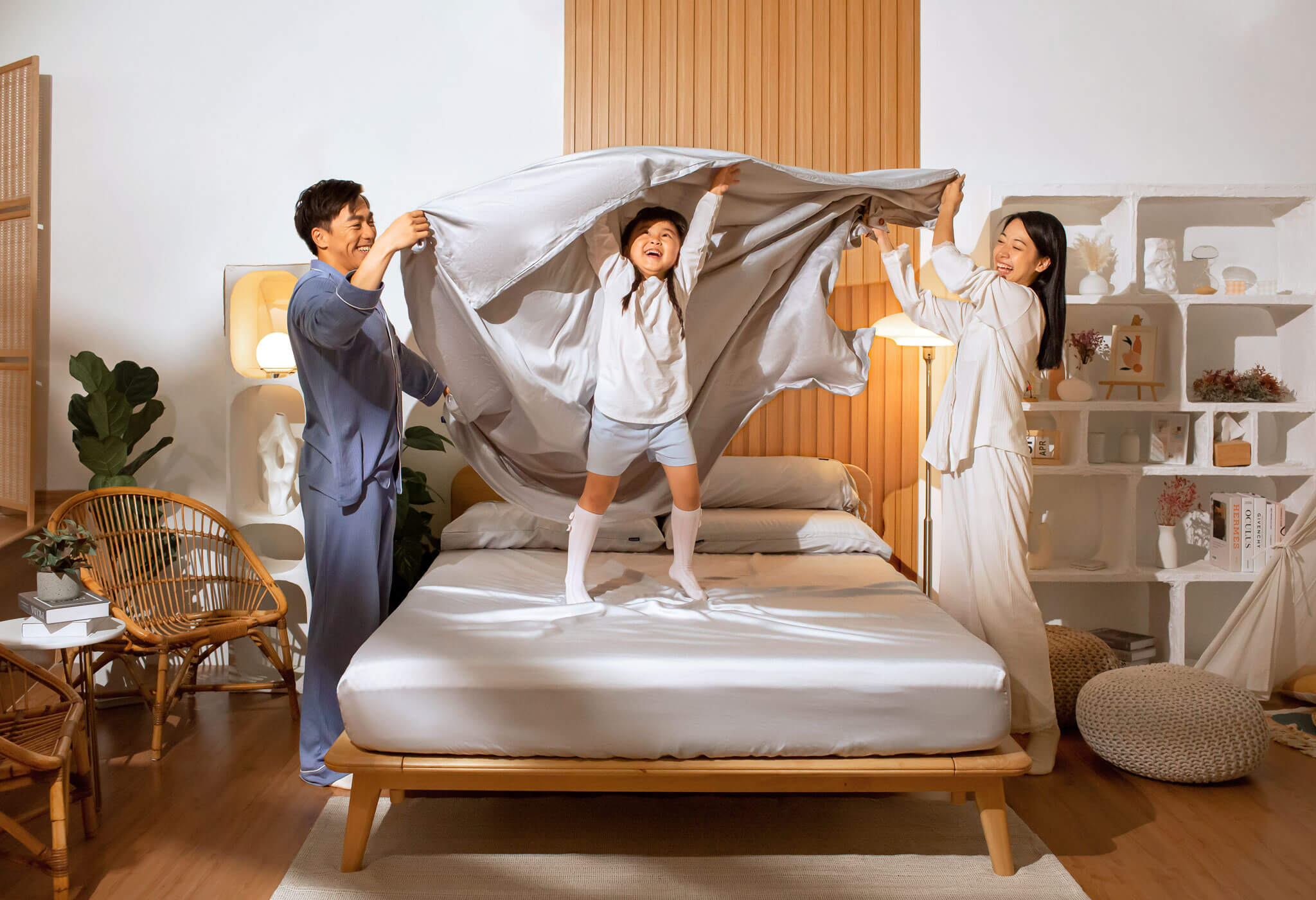 Happy family playing with the Sonno nimbus cloud Bed Sheet in a Japandi bedroom