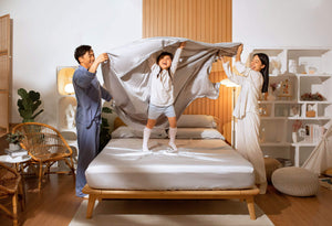 Happy family playing with the Sonno nimbus cloud Bed Sheet in a Japandi bedroom